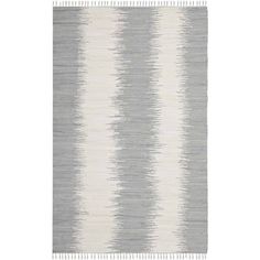 a rug with grey and white stripes on it