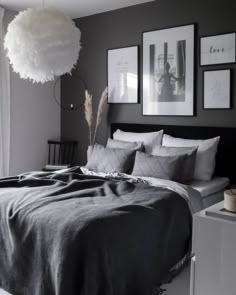 a black and white bedroom with pictures on the wall