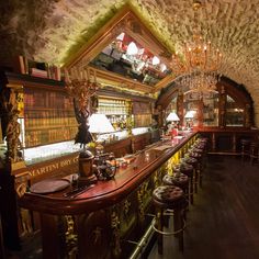 an old fashioned bar with lots of stools