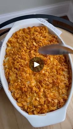 a casserole dish is being served on a table with a serving utensil