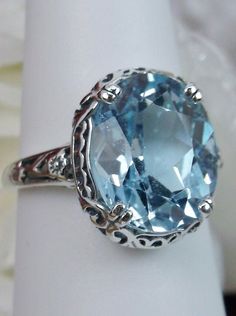 Natural Sky Blue Topaz Ring, 4.5 carat oval faceted stone, sterling Silver floral filigree, Edward design #D70z, side view Blue Topaz Gemstone, Sky Blue Topaz, Filigree Ring, Blue Gemstones, Silver Filigree, Topaz Gemstone, Topaz Ring, Leaf Design, Blue Topaz