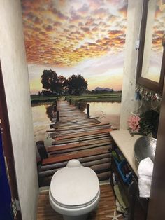 a toilet sitting on top of a wooden floor in a bathroom