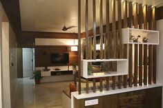 a living room filled with furniture and a flat screen tv on top of a wooden shelf