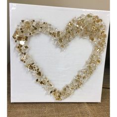 a heart made out of glass beads on a canvas