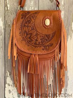 Show your personality with the Crystal Moon Leather Fringed Boho bag. The Crystal Moon bag is a stunning piece. A Beautiful Hand tooled bohemian style bag with a feature gem, a must for any bohemian wardrobe. Handmade Genuine Leather Magnetic Close on front flap, zipper close inside under flap. Inside bag- Zip pocket and 2 open pockets Lined Measurements - Approx W26cm x H26cm Strap length Approx - 124cm Colour -Tan or chocolate Please keep in mind that leather is a natural product and colour va Bohemian Brown Shoulder Bag, Bohemian Brown Shoulder Bag For Festival, Handmade Bohemian Leather Shoulder Bag, Handmade Bohemian Bags, Bohemian Brown Hand-tooled Shoulder Bag, Bohemian Hand Tooled Shoulder Bag, Handmade Brown Bohemian Shoulder Bag, Handmade Bohemian Brown Shoulder Bag, Bohemian Hand-tooled Brown Bag