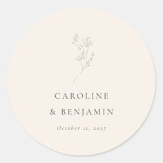 a round wedding sticker with the words, name and date printed in silver ink