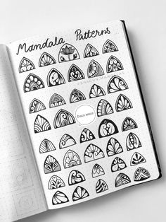 an open notebook with black and white designs on it