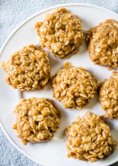 a white plate topped with cookies covered in oatmeal