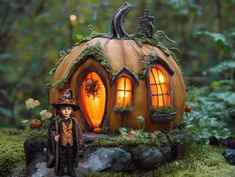 a little boy standing in front of a pumpkin shaped house with lights on it's windows