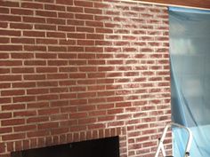 a brick fireplace with a blue tarp covering it