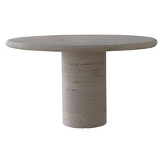 a round concrete table sitting on top of a white floor