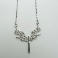 Our angel necklace, silver-plated and decorated with sparkling zirconia, is a real eye-catcher. The pendant was designed with attention to detail and radiates a heavenly beauty. The delicate angel wings symbolize protection and harmony, while the zirconia stones provide subtle shine. This piece of jewelry is perfect for any occasion and adds a touch of elegance and spirituality to your look. Elegant Silver Necklace With Angel Wings, Elegant Silver Winged Necklace, Elegant Winged Silver Necklace, Silver Angel Wings Pendant Necklace, Nickel Free Jewelry, Angel Necklace, Angel Wings, Charm Necklace, Necklace Lengths