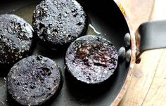 chocolate muffins in a frying pan on a wooden table