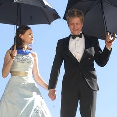 a man and woman holding umbrellas in their hands