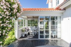 an outdoor patio with sliding glass doors leading to the back deck and dining room area