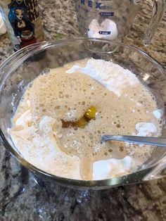 a glass bowl filled with batter and ingredients