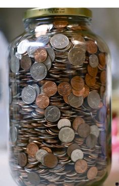 a glass jar filled with lots of coins