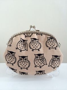 an owl print coin purse is shown on a white surface