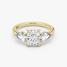 three stone engagement ring in yellow gold