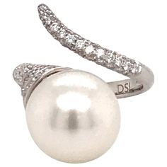 18K White gold ring featuring one South Sea Pearl measuring 13-14 MM flanked with 85 round brilliants weighing 0.79 carats. Color G-H Clarity SI Measurements: South Sea Pearl: 13-14 MM Nail Band: 2.8 MM Ring can be sized. Pearl can be changed to Pink, Tahitian, or Golden Nail Ring, Diamond Nails, Sea Pearl, South Sea Pearls, Sea Pearls, Pearl Diamond, Gold Nails, Ring Ring, Tahiti