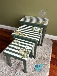 three tables with flowers painted on them sitting on a rug in front of a wall