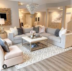 a living room filled with furniture and a chandelier