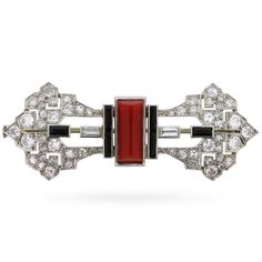 Dating from the 1920s, a stunning Art Deco period brooch set in platinum with a combination of coral, onyx, and baguette and old cut diamonds. Chic and sophisticated, this striking piece is composed of strong geometric elements, juxtaposed with a hint of Art Nouveau influence in its outline. The brooch is fitted to the reverse with a hinged pin and a … Vintage Jewelry 1920, 1st Dibs, Jewellery Art, Rene Lalique, 1920s Art, 1920s Art Deco