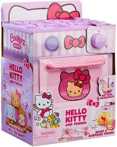 the hello kitty toy oven is pink and has hello kitty on it's front