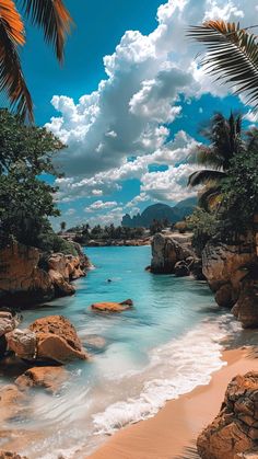 the beach is surrounded by palm trees and blue water with white clouds in the sky