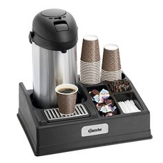 a coffee maker and tray with cups on it