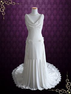 a white wedding dress on display in front of a purple wall