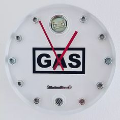 a white clock with the words gas on it's face and two red hands