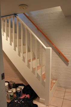 the stairs are being painted white in this room