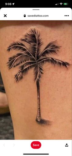 a small palm tree tattoo on the back of a woman's thigh, with an arrow