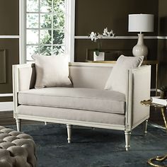 a living room with a white couch and pillows