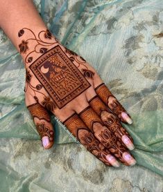 a woman's hand with hennap and intricate designs on the palm,