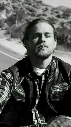 black and white photograph of a man on a motorcycle