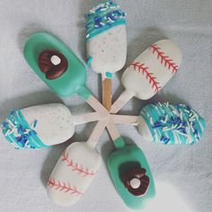 six baseball themed cake pops are arranged in a circle