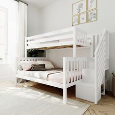 a white bunk bed sitting next to a stair case in a room with hardwood floors