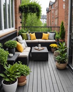 a balcony with lots of plants and couches