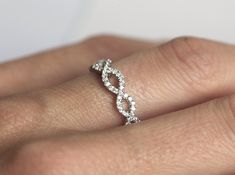 a woman's hand with a diamond ring on it