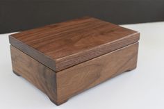 a wooden box sitting on top of a white table