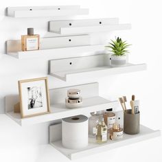 three shelves with various items on them and one shelf has a plant in the corner