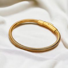 ✨ Gold Bangle Bracelet ✨ Introducing our exquisite Gold Bangle Bracelet, crafted for timeless elegance and versatility. Ideal as a gift for her, bridesmaids, weddings, or birthdays, this minimalist accessory enhances any outfit with its sophisticated design. Elevate your style with this must-have piece of personalized jewelry. ✨FREE DELIVERY✨  ✨What's Included: 1x 18k Gold styled Stainless Steel Gold Bangle Bracelet (6cm x 0.4cm) ✨M A T E R I A L✨ Stainless Steel  ✨S I Z E✨ 6cm x 0.4cm  10.0g *- Adjustable Jubilee Snake Chain Bracelet, Adjustable Snake Chain Bracelet For Everyday, Gold Bracelets With Lobster Clasp For Wedding, Flexible Gold Cuff Bracelet As Gift, Minimalist Flexible Bracelets For Gifts, Adjustable Gold Bracelets For Bridesmaids, Adjustable Gold Bracelet For Bridesmaid Gift, Gold-colored Stainless Steel Wedding Bracelet, Flexible Bangle Bracelet As Gift