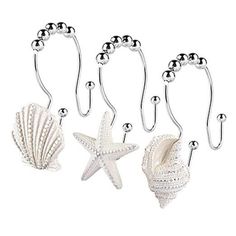 three sea shells and two starfish hooks