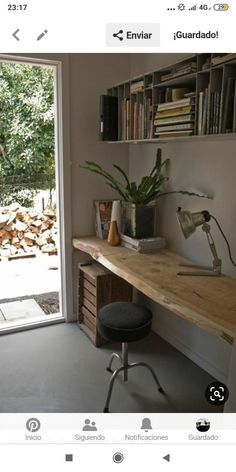 a room with a desk, chair and bookshelf next to a sliding glass door