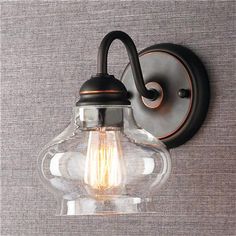 a light that is on the wall next to a gray wall with a black handle