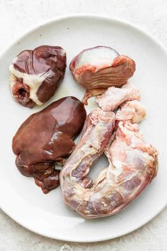 an assortment of meats on a white plate