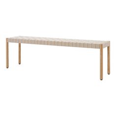 a white and beige bench sitting on top of a wooden table