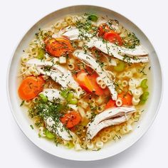 a bowl of chicken noodle soup with carrots and celery